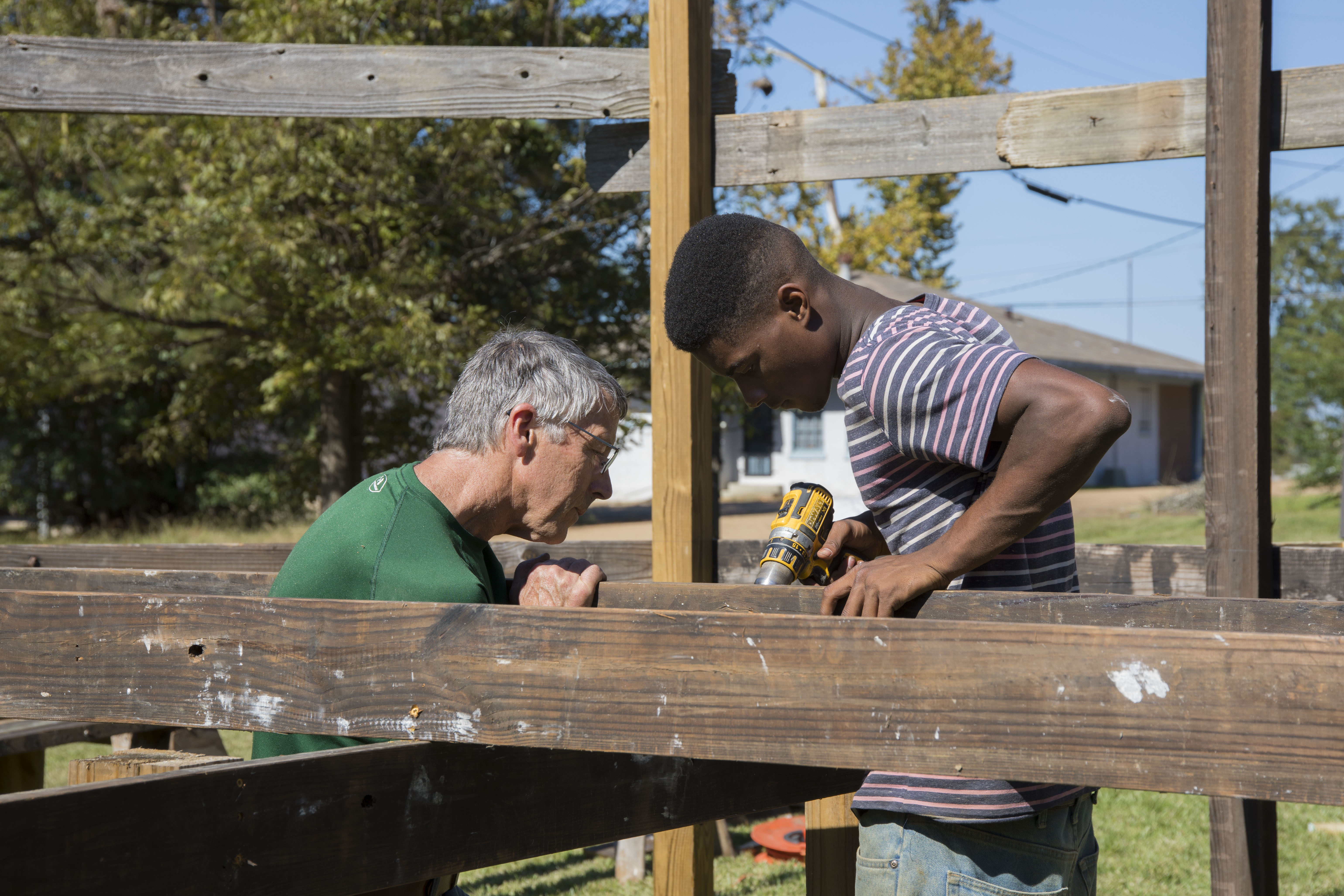 Youth Apprentices build out huge porch and learn new skills with visiting master builder, Ben!